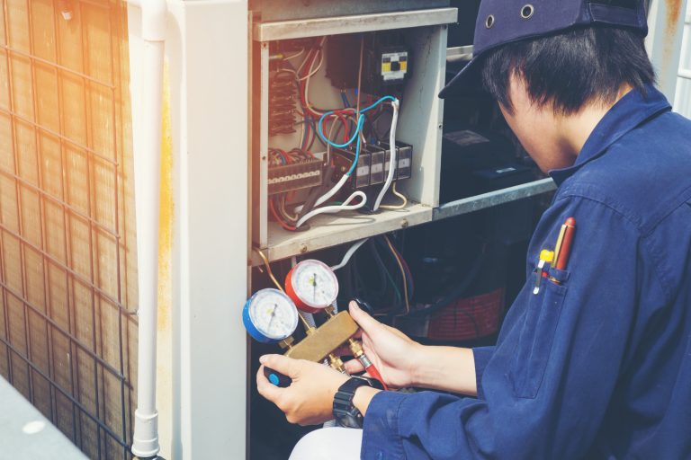 HVAC technician working on an air conditioner in South Florida